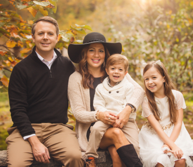 Darl Champion sitting with wife and two kids in autumn