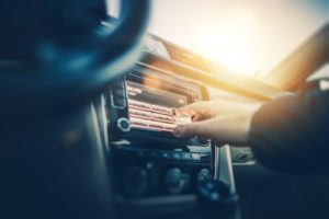 Car Radio Listening. Car Driver Changing Radio Stations on His Vehicle Multimedia System. Modern Touchscreen Audio System.