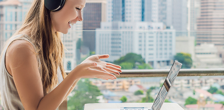 Happy woman having meeting on laptop
