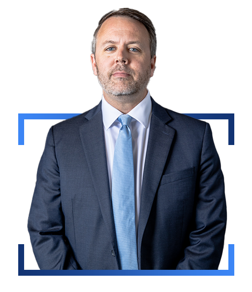 Headshot of Darl Champion, man with trimmed beard in navy blue suit with light blue tie and white shirt. Design element of blue lines on image