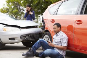 Driver using phone after traffic incident, emphasizing distracted driving and post-accident communication.