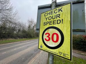 Roadside speed check sign indicating a speed limit of 30mph. High-visibility cautionary signage for drivers.