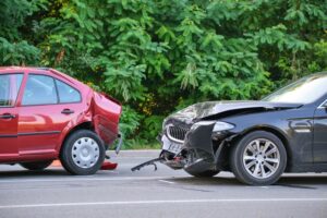 Two wrecked vehicles at a collision site on a city street in Marietta after a severe car accident.