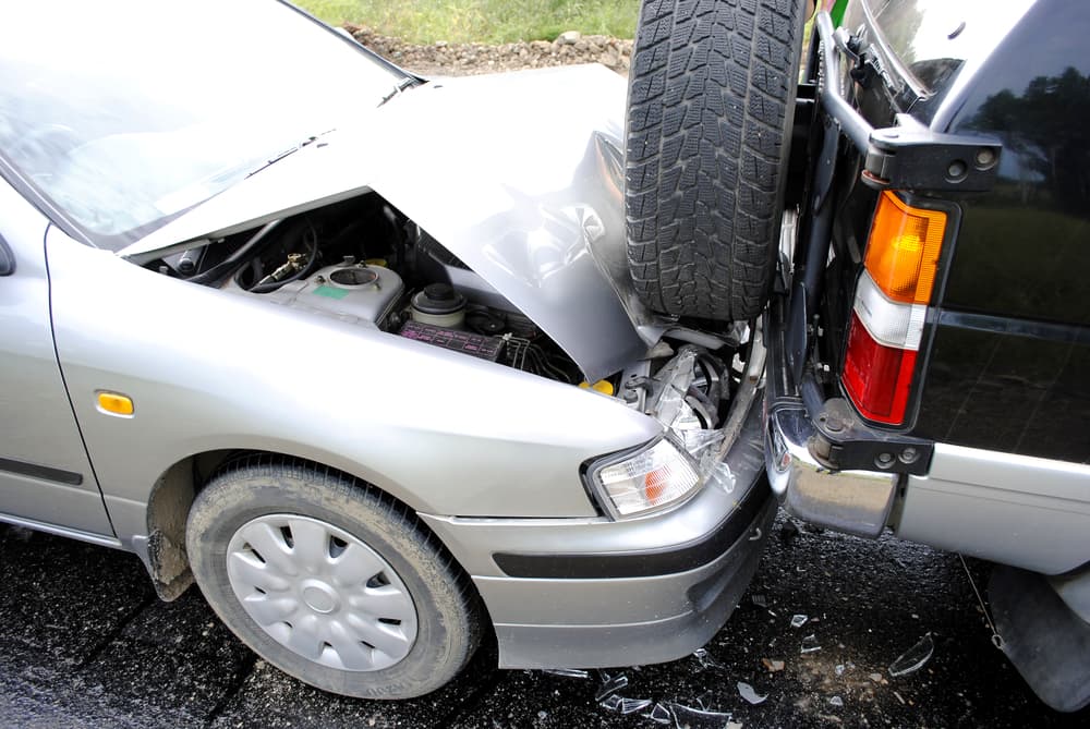 Automobile collision scene on a busy highway.
