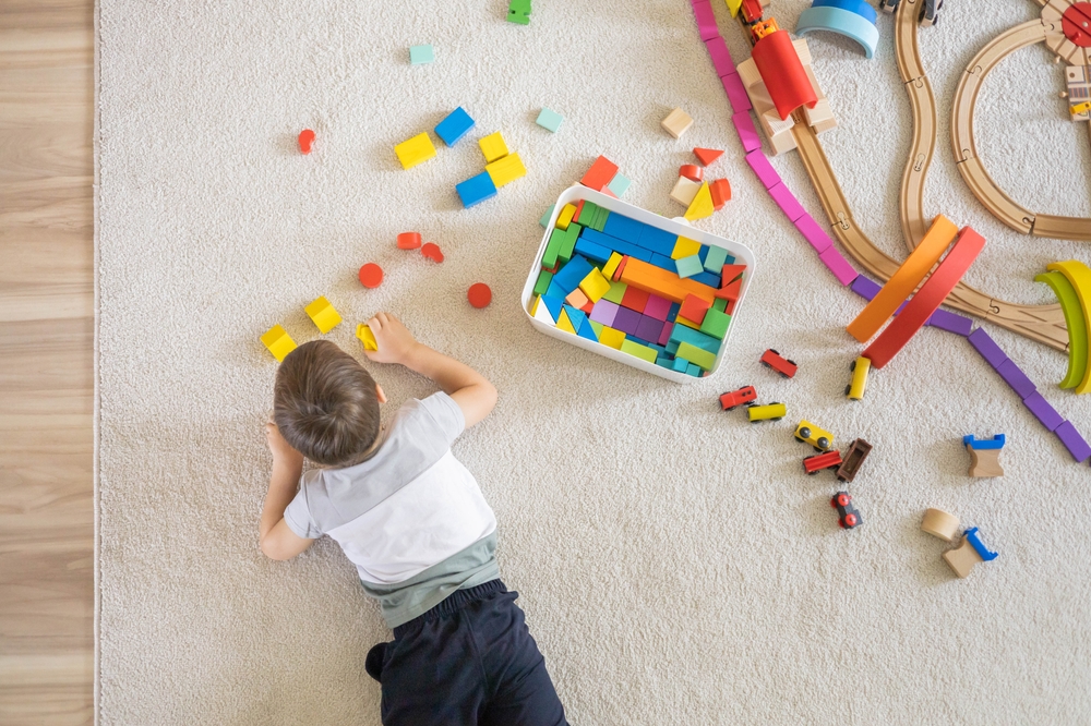 child playing with small toys