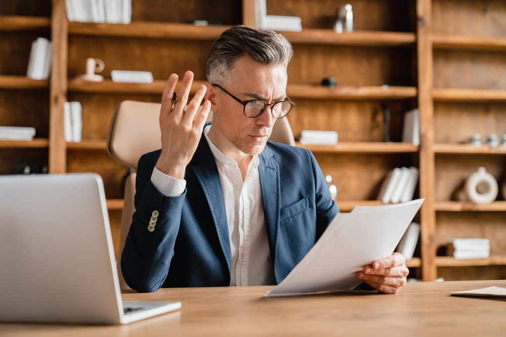 Lawyer sitting at his computer frustrated