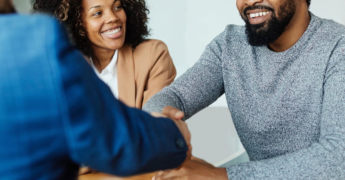 client shaking hands with attorney at settlement